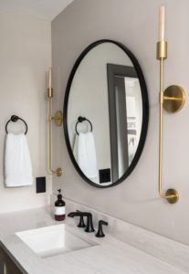 bathroom mirror and gold light sconces